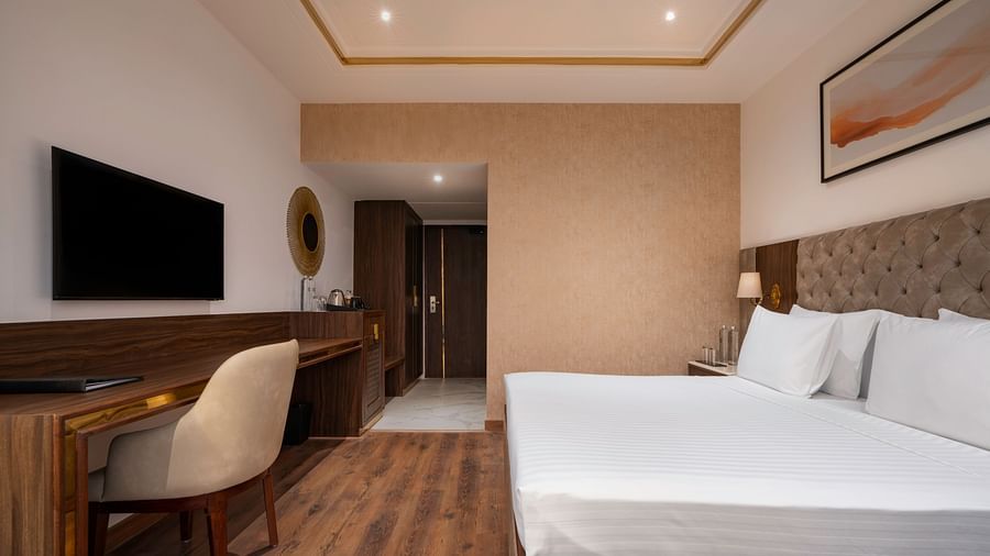 Modern hotel room with a minimalist design and natural light - Clarks Inn, Dehradun