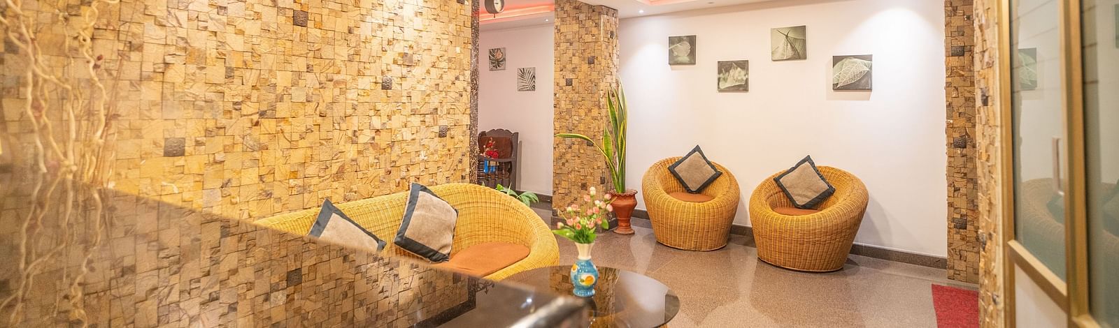 A seating area with ratan furniture at Parampara Residency, Kushalnagar.