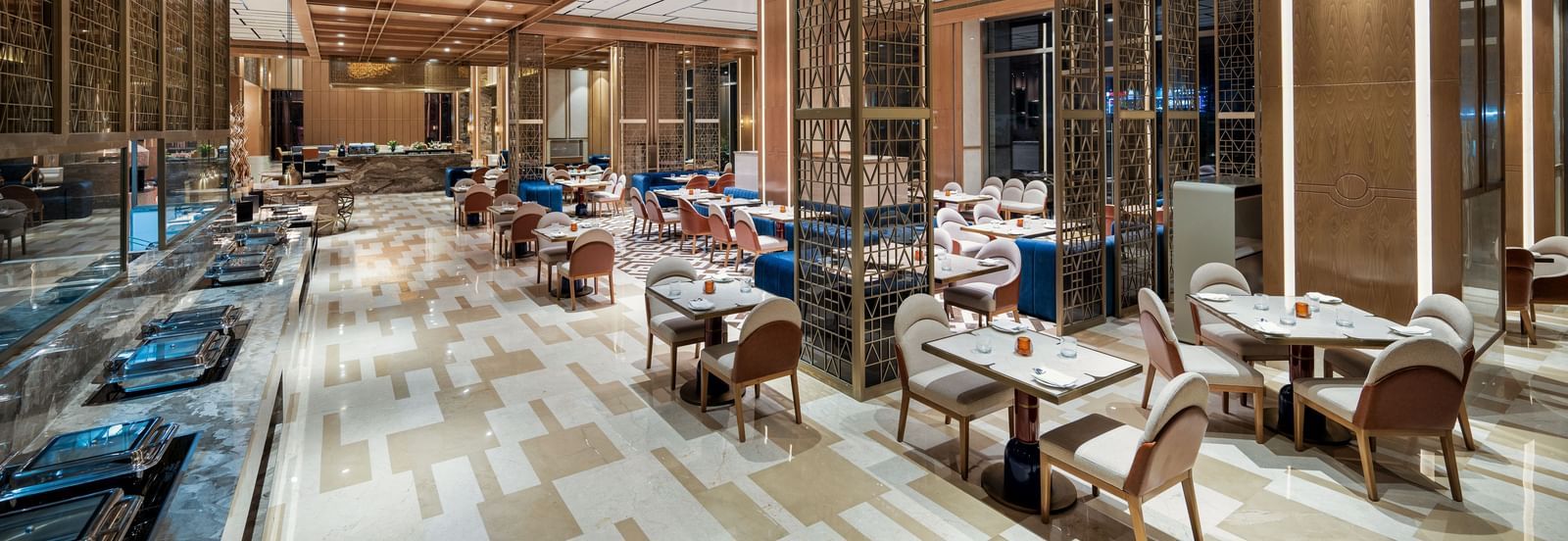 Warm and elegant dining area with wood accents and modern seating at Merlis Hotel, Coimbatore.