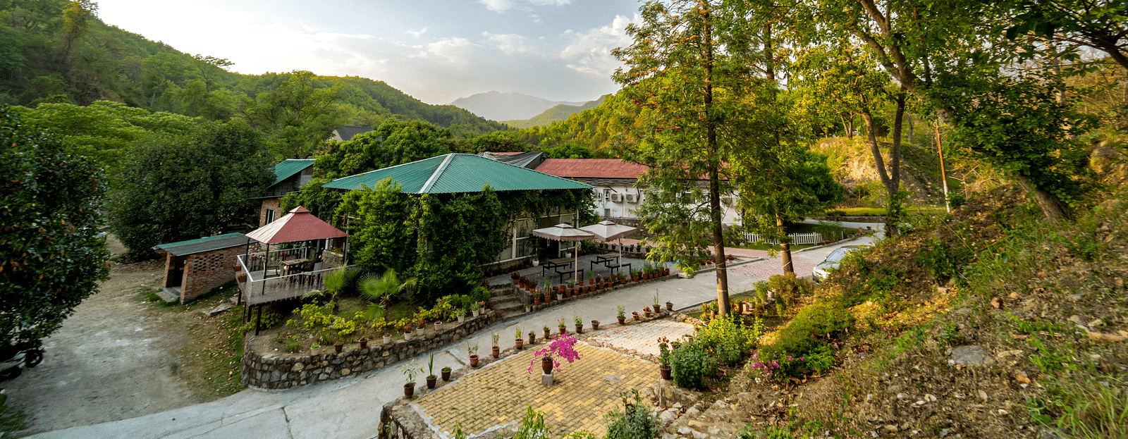 An exterior view of The Sylvan Retreat, Dehradun amongst greenery.
