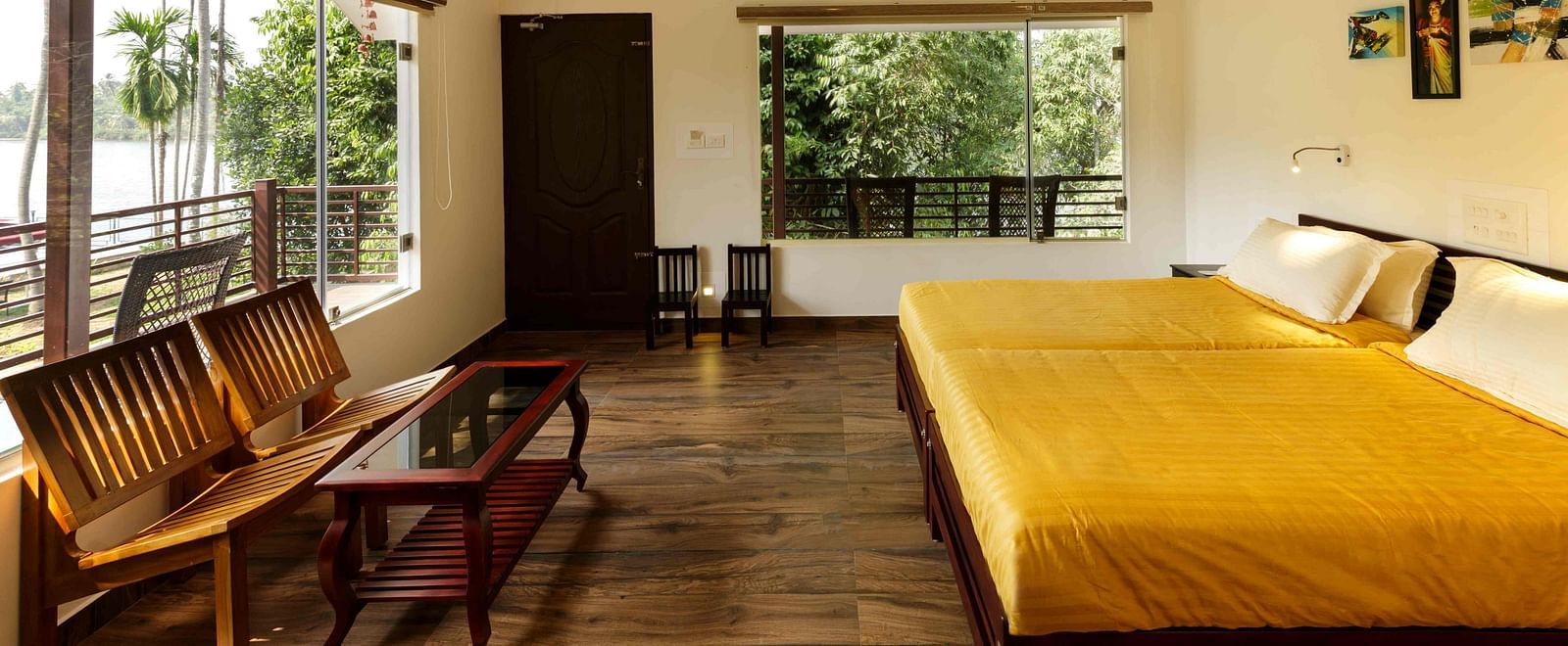 A bedroom with a bed, wooden furniture, and a view of the outside.