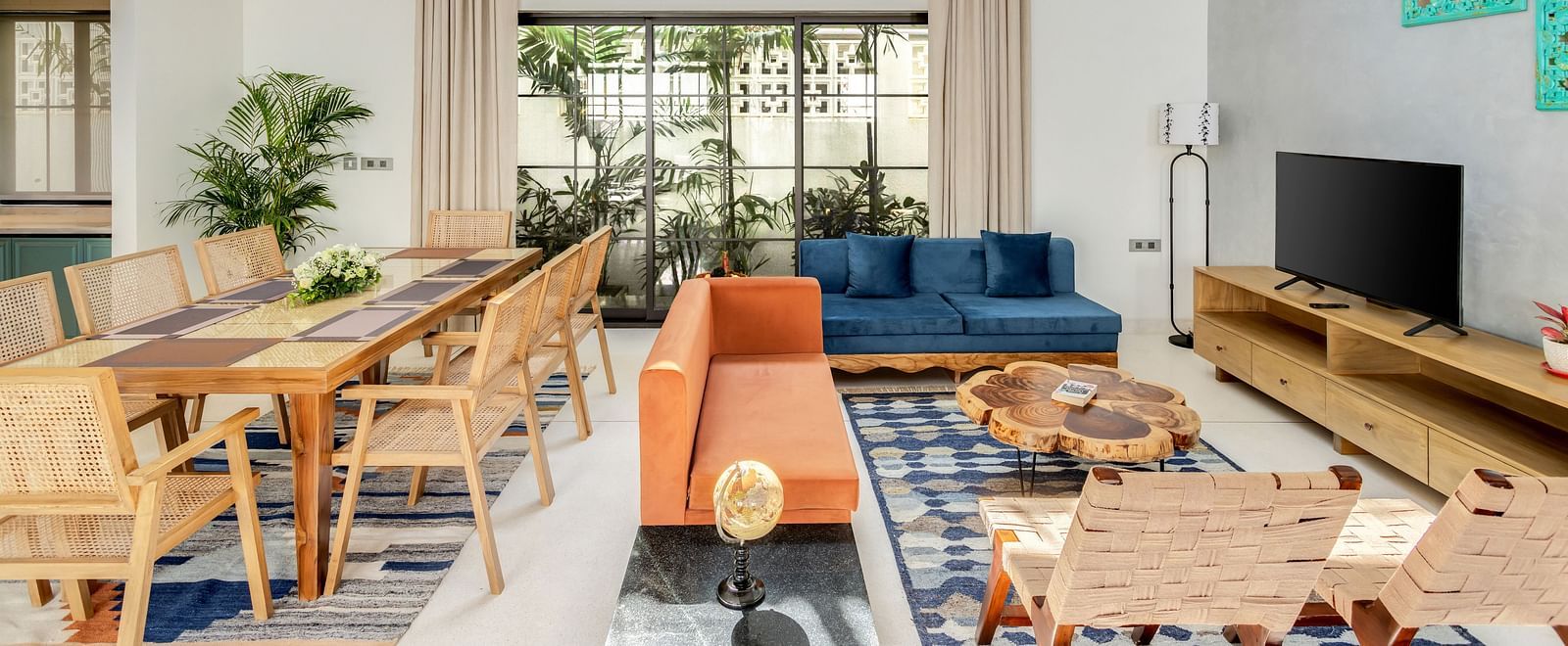 A spacious living and dining room with high ceilings, contemporary furnishings, and large windows flooding the space with natural light - BluSalzz Villas - Alocassia, Anjuna