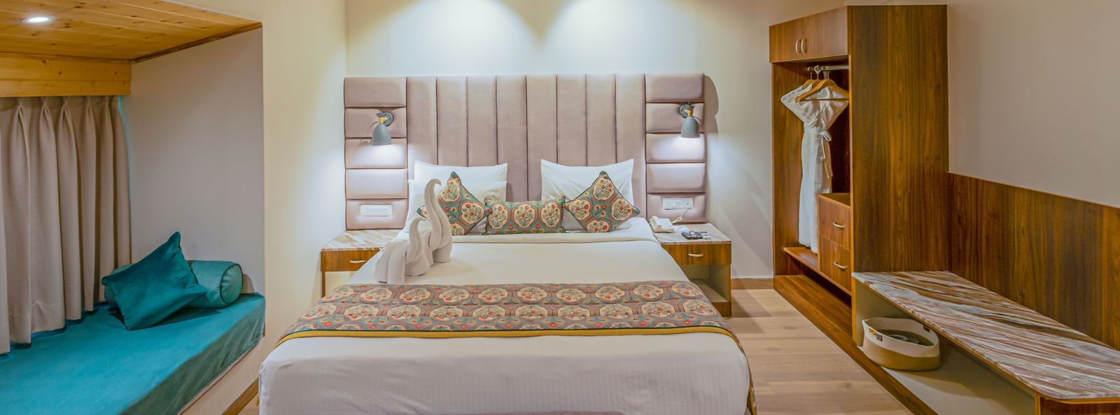Sajjan Villa with Jacuzzi at Bamboo Saa Resort and Spa, Udaipur featuring a double size bed, a bedside table, a small bed near the window, a wardrobe, a ceiling fan, and a workstation.