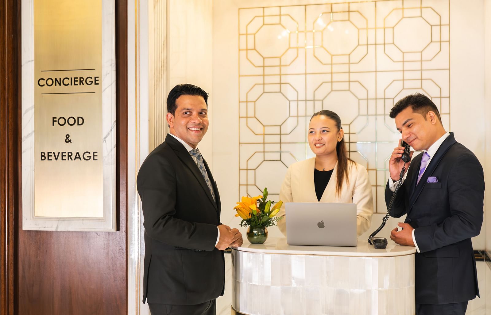 image of people dressed in business formals at logo of the Cinqtuair spa at The Claridges New Delhi