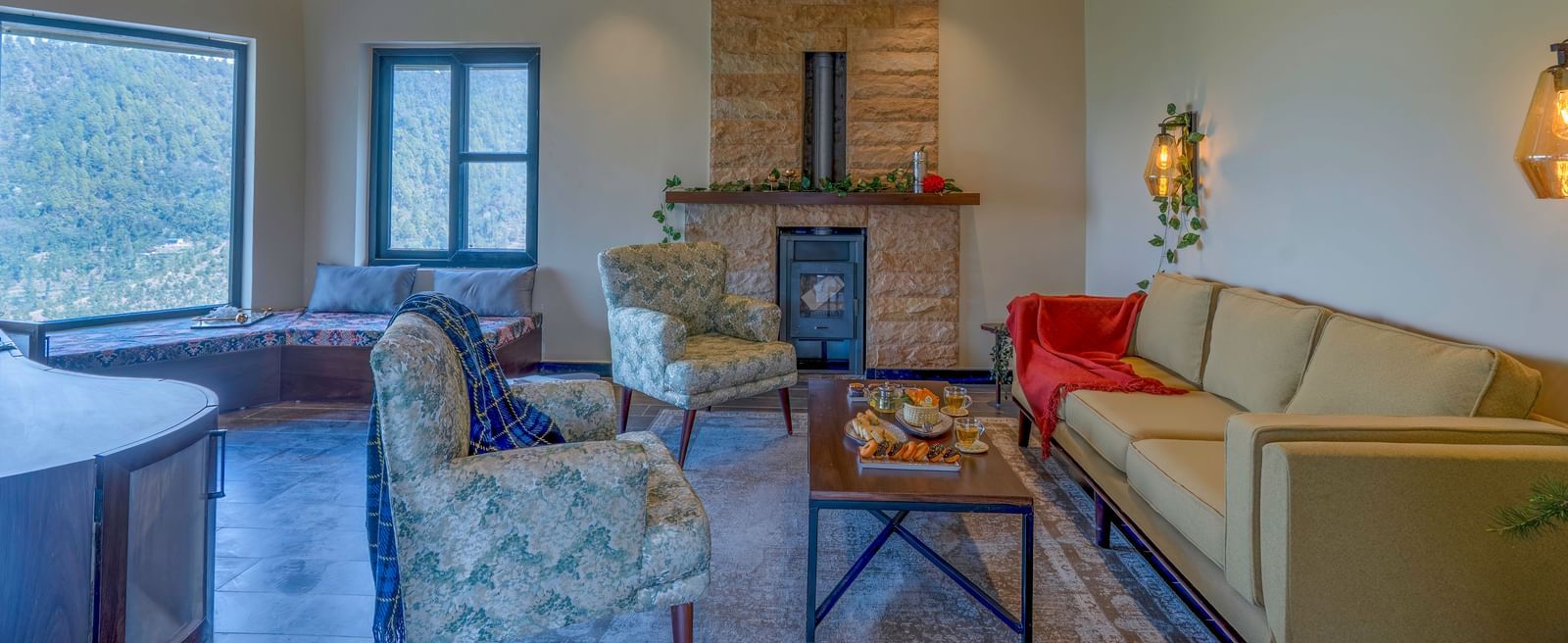 Living area with a fireplace, sofas, and a high, beamed ceiling at The Chamomile Estate.