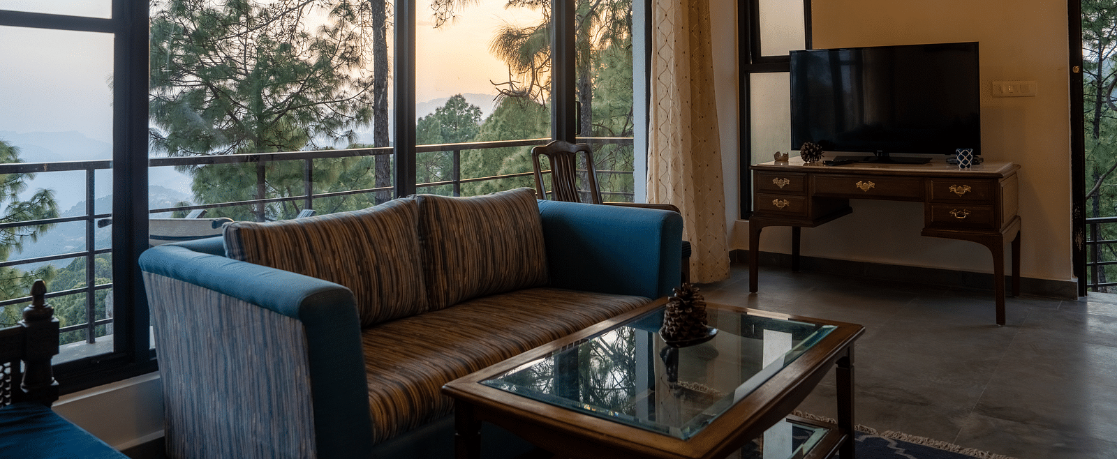 A suite living room with a television placed on the table at BluSalzz Escapade Resort, Lansdowne.