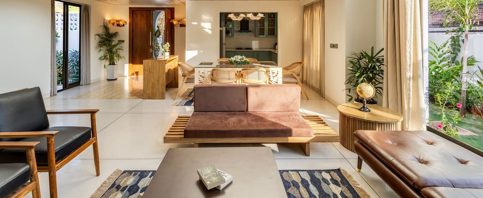 A stylish living area with a minimalist design, ample sunlight, and an open layout connecting to the outdoors - BluSalzz Villas - Alocassia, Anjuna