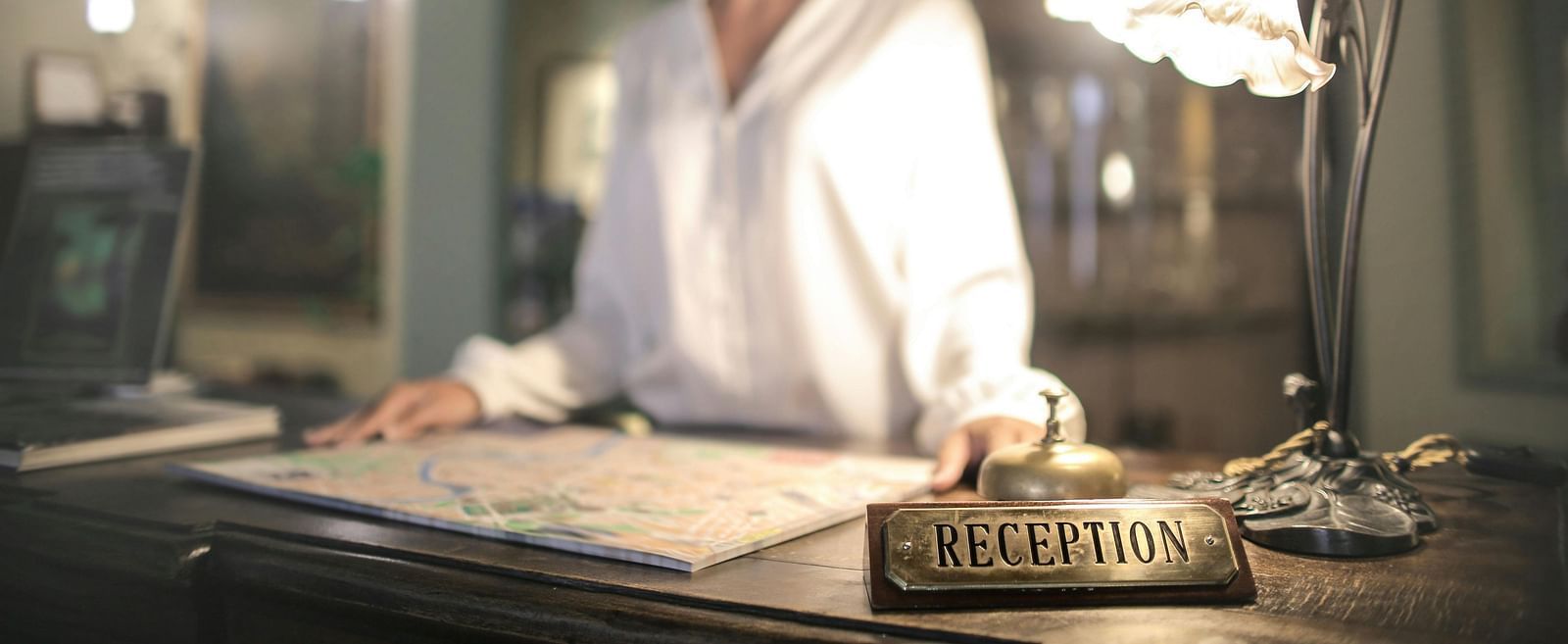 Image of a lady at the reception desk.