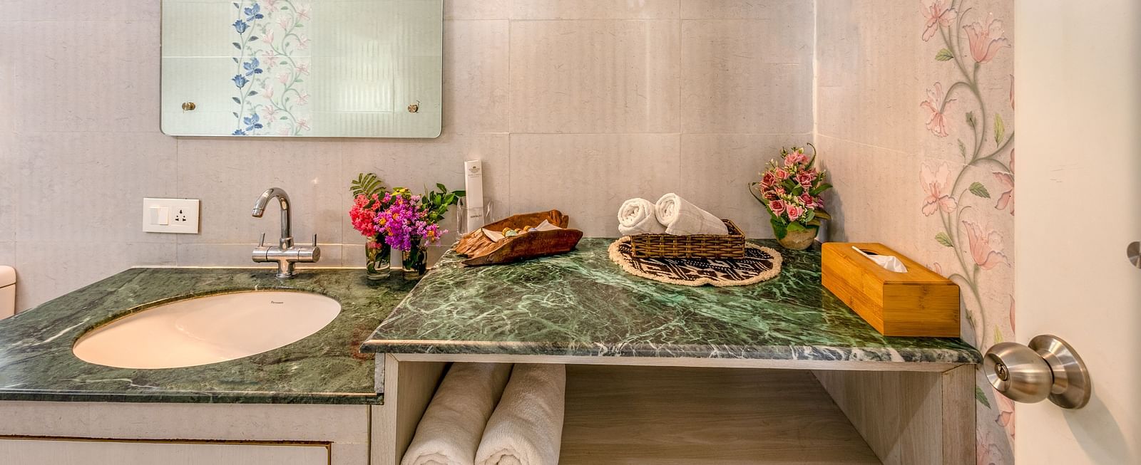 an overview of the bathroom with sink area in view inside one of the rooms - neer ganga resorts