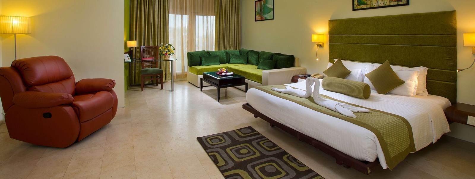 Family suite featuring a bed, a sofa and recliner at Hotel Atithi - TGI Grand, Pondicherry
