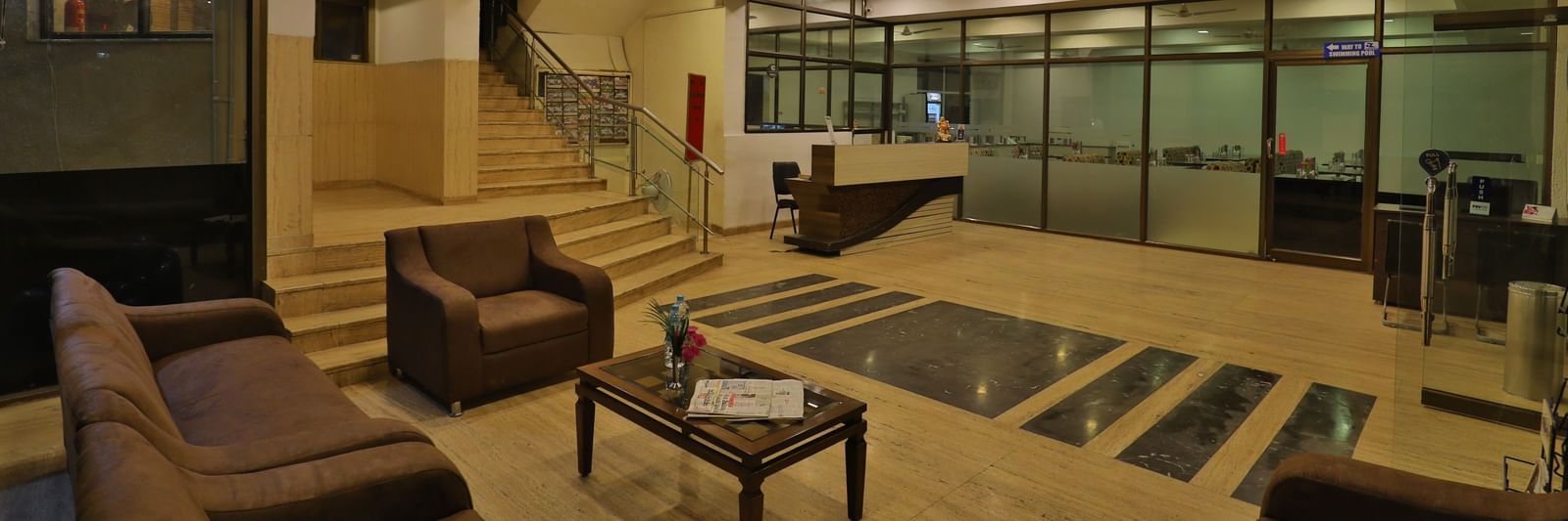 A hotel lobby and lounge area with stylish seating, wooden accents, and contemporary lighting - Retreat Heritage, Lonavala