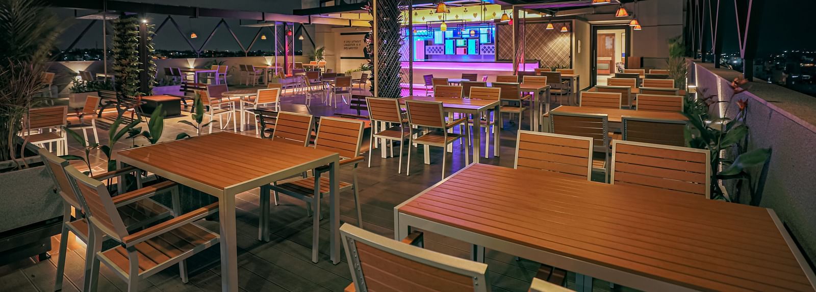 Image of a dining area with wooden tables and chairs at M Pro Palace.