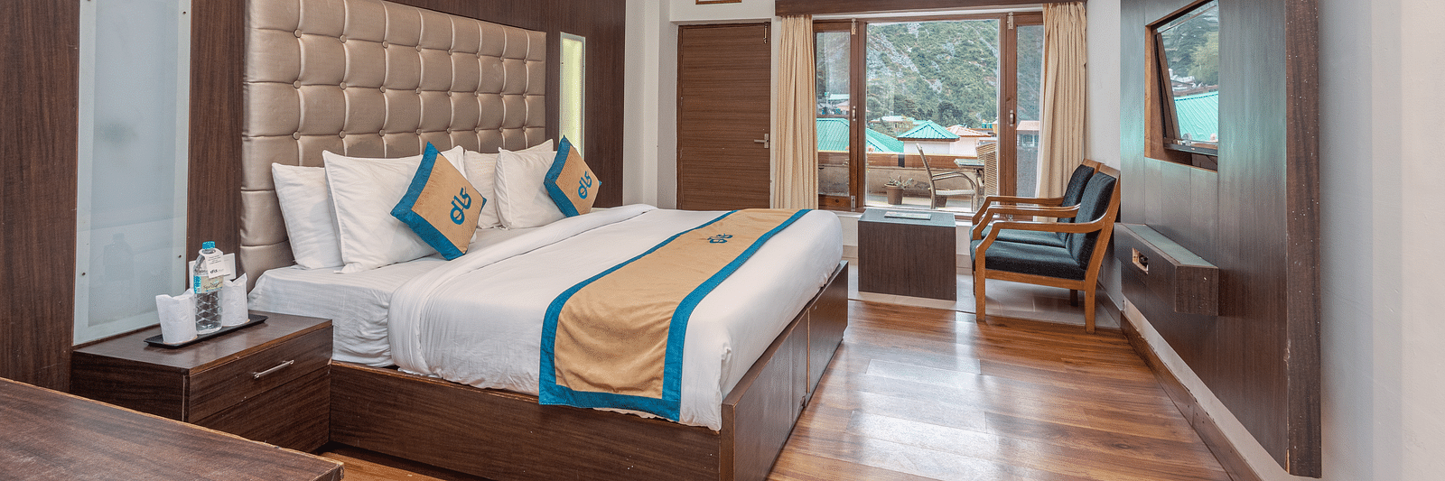 Overview of Premium Room at DLS Spring Valley Resort Dharamshala featuring a king size bed, chair and a balcony