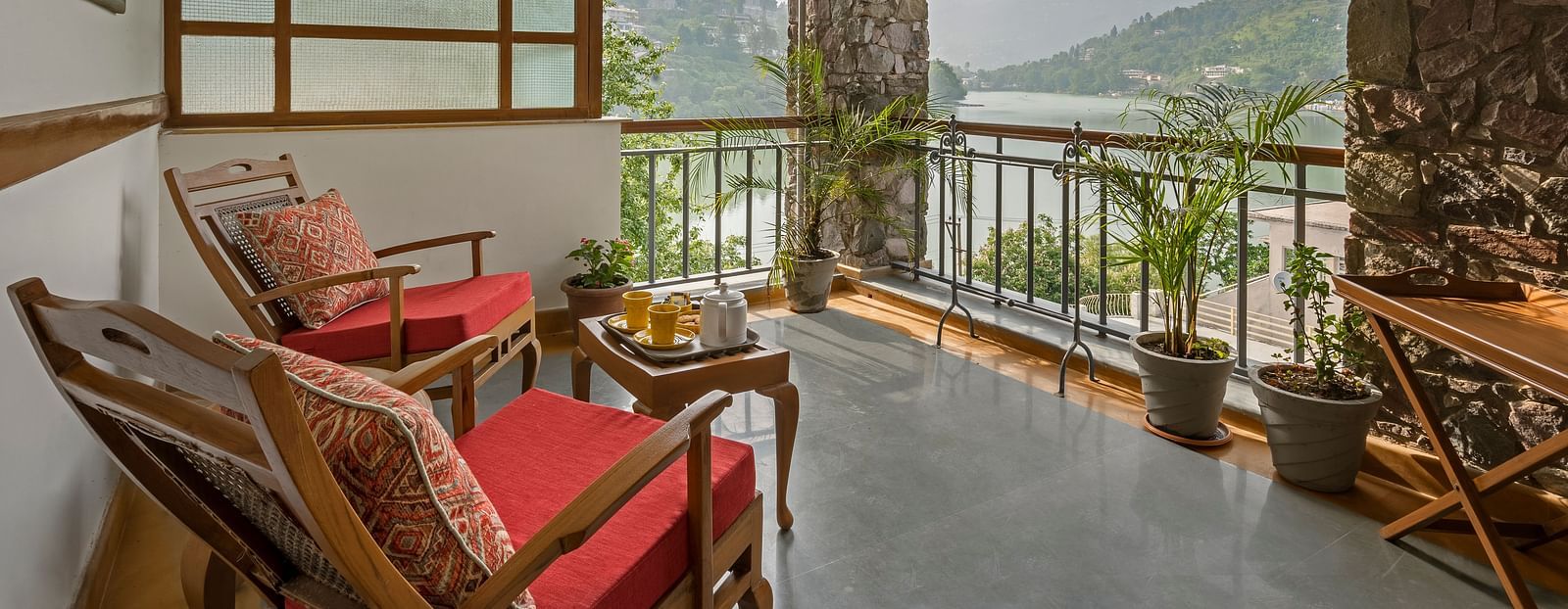 Sitting area with a beautiful view in the Superior Rooms at Fishermen's Lodge, Bhimtal, perfect for enjoying the serene surroundings.