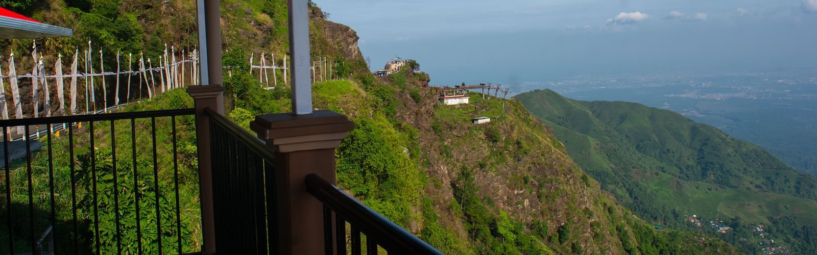 Valley view from a balcony showcasing mountains and clear sky
