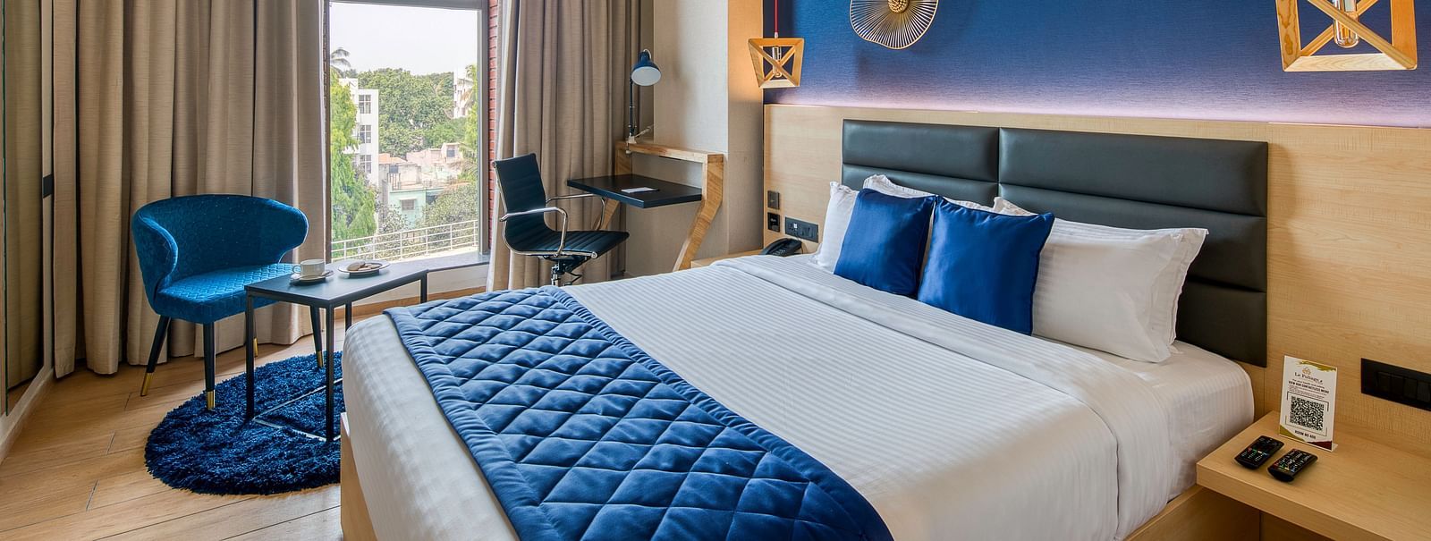 Side view of the double bed at the Premium Room at Le Foliage by TGI, Bangalore