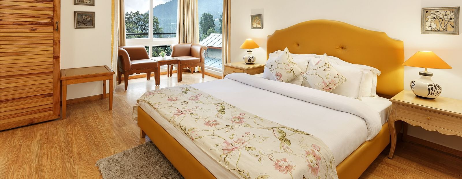 Hotel room featuring a cozy king-sized bed and a scenic view from the window.