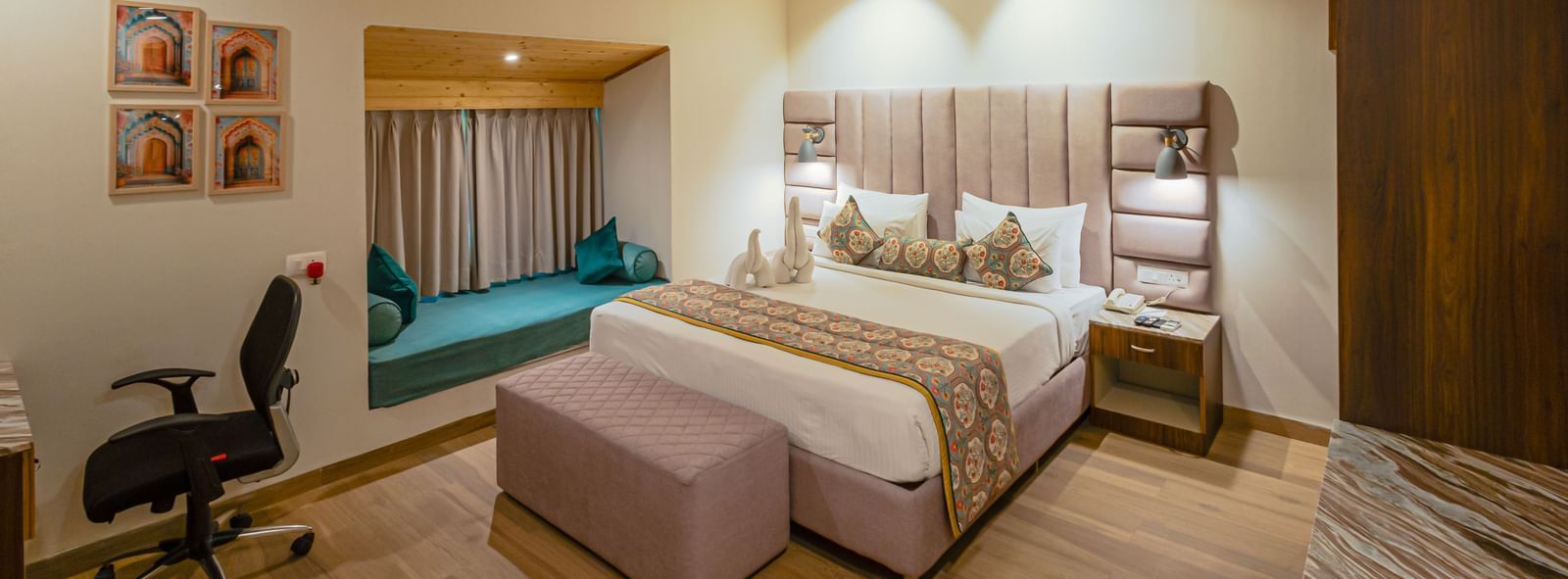 Sajjan Villa with Jacuzzi at Bamboo Saa Resort and Spa, Udaipur featuring a double size bed, a bedside table, a small bed near the window, a ceiling fan, and a workstation.
