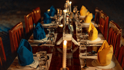 Barefoot at Havelock offers a candlelit beachside dining experience, with an elegantly set table creating a romantic evening by the sea