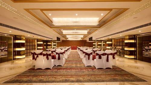 A large banquet hall with chairs arranged in a class room type seating