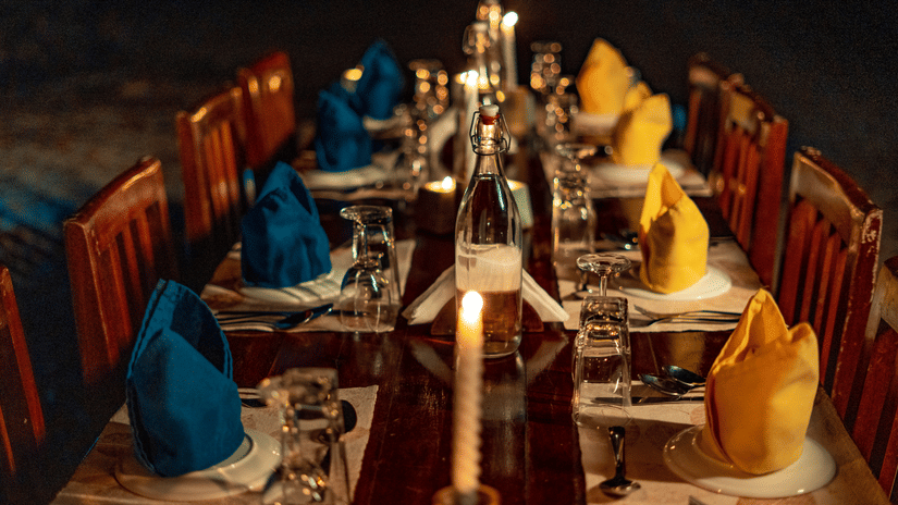 Barefoot at Havelock offers a candlelit beachside dining experience, with an elegantly set table creating a romantic evening by the sea