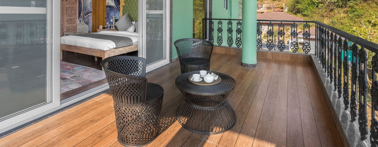a balcony with a small table and chairs for sitting - Atman, Dharamshala