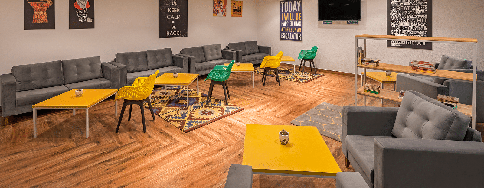 An image of interior of lounge area featuring sofas and bean bags for relaxation, coffee tables.