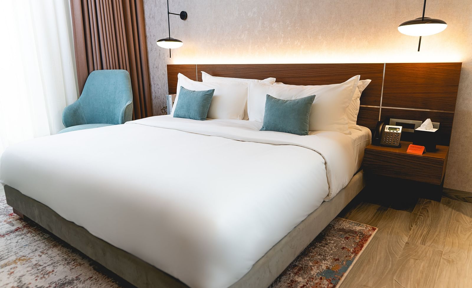 An overview of a bedroom with plush bedding inside two bedroom suite - kertel suites, kinshasa