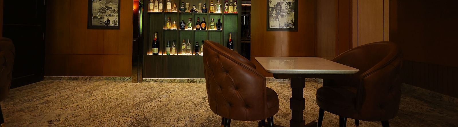 Wide angle image of a fully stocked bar rack at JBs lounge of Hotel Amar