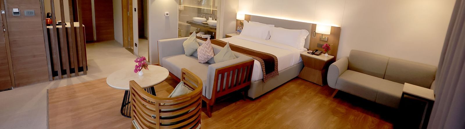 Room with wooden flooring, soft ambient lighting, and a welcoming seating corner at Wyndham Garden.