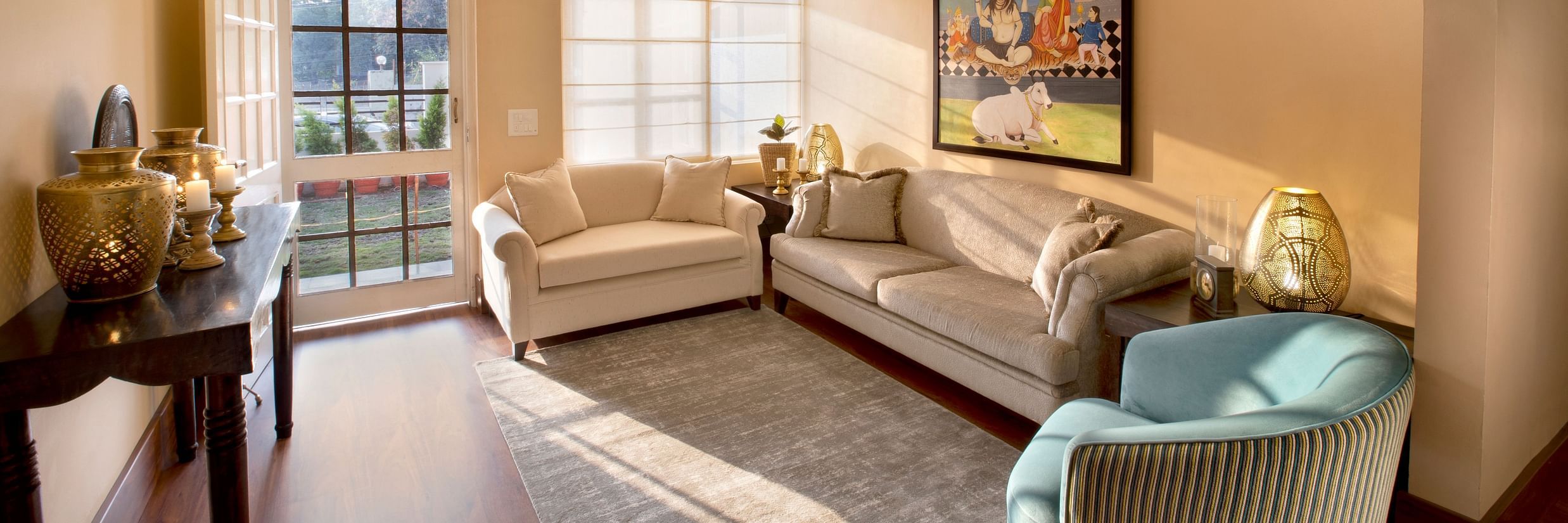 An image of a living room features comfy sofas and large windows 4 - Lamrin Boutique Cottages Rishikesh