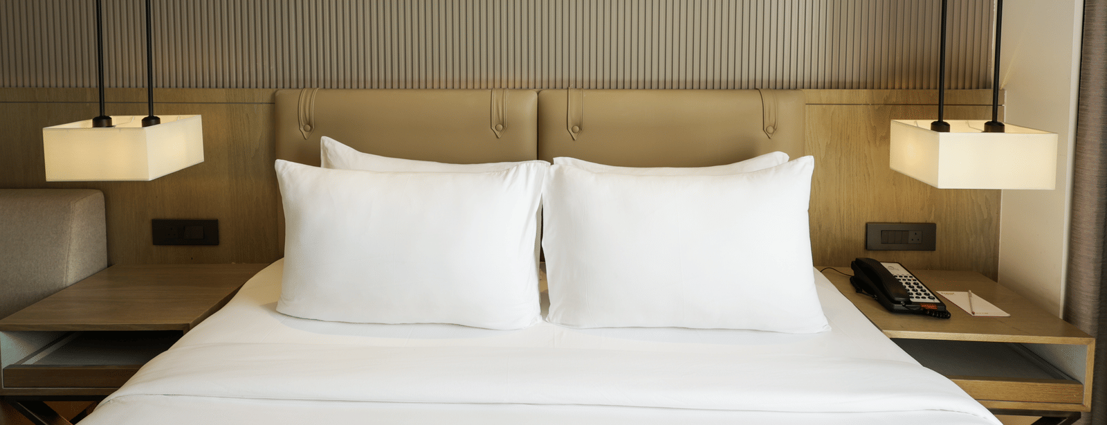 Elegant room with a bed and floral artwork above the headboard at Ramada by Wyndham Sonipat Murthal