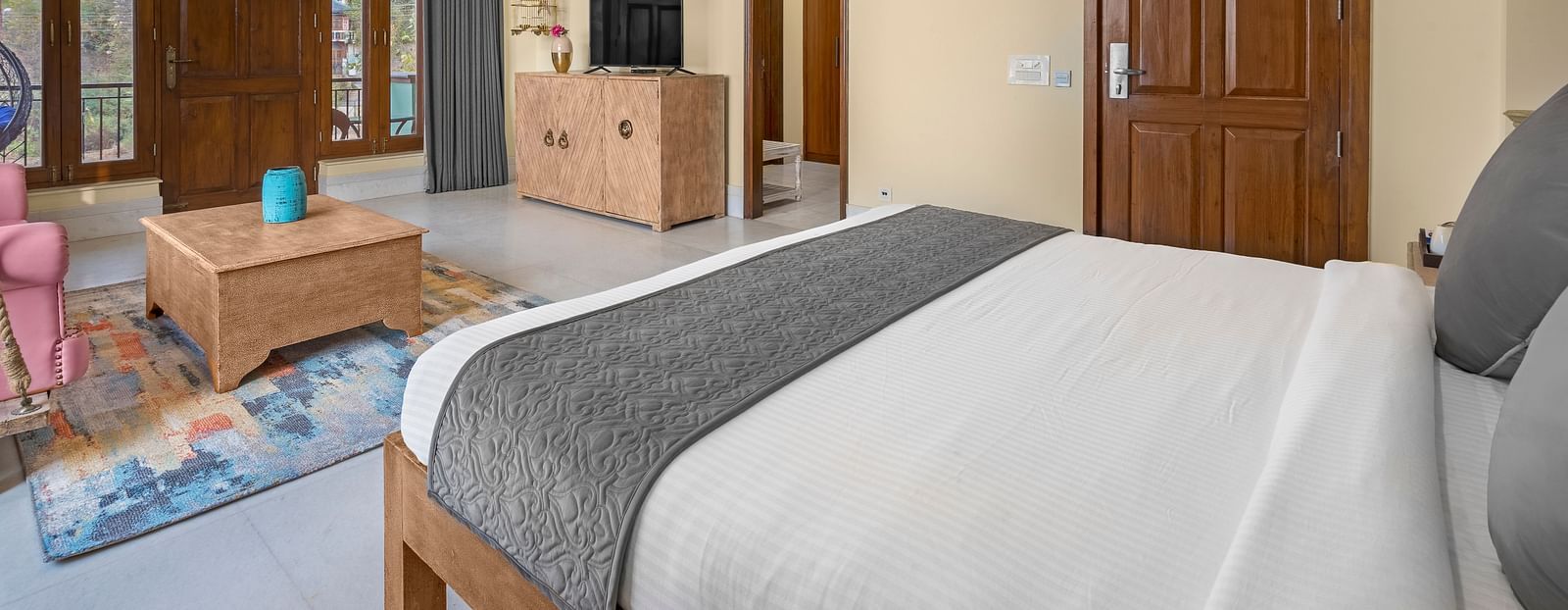 An image of a Luxurious bedroom with a chandelier, a plush bed, and elegant decor - Atman, dharamshala