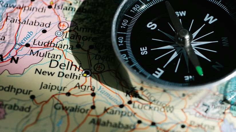 Compass placed on a map for navigation and travel direction.