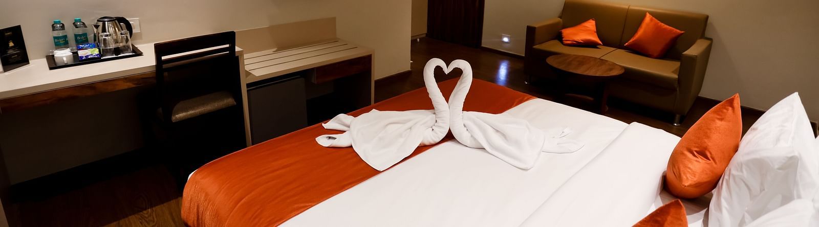 Side view of a bed a with a television in front at Calux Grand Baga.
