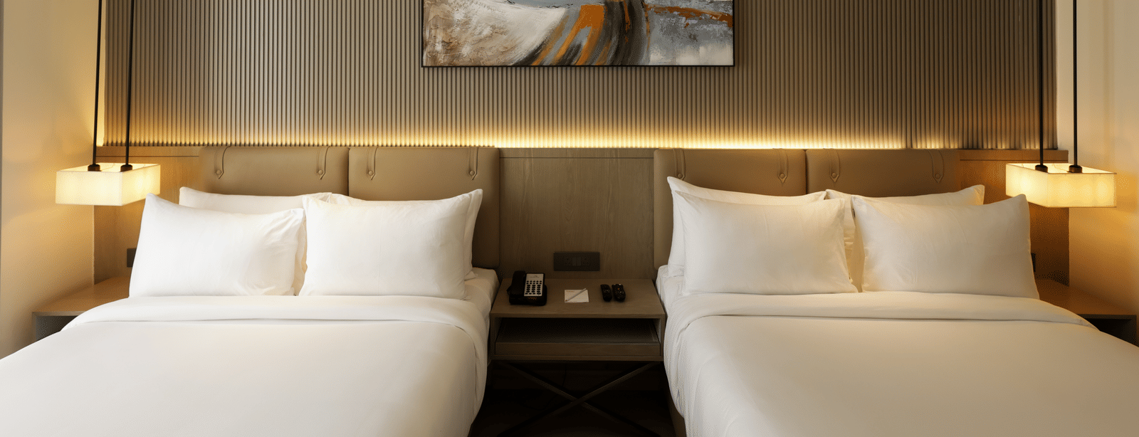 Room with soft lighting, grey accent wall, and abstract wall art at Ramada by Wyndham Sonipat Murthal