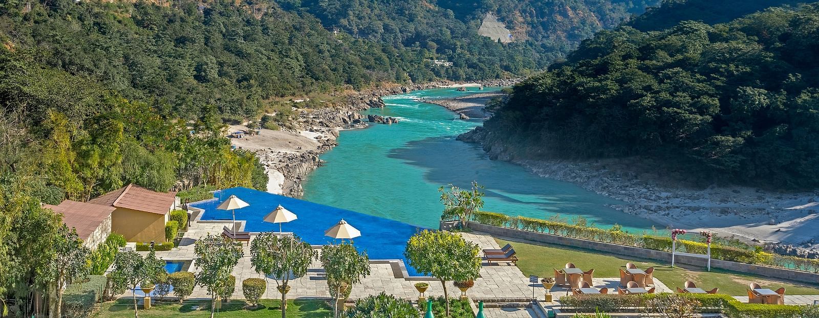 An image capturing a breathtaking landscape featuring a serene river winding through a mountainous valley.