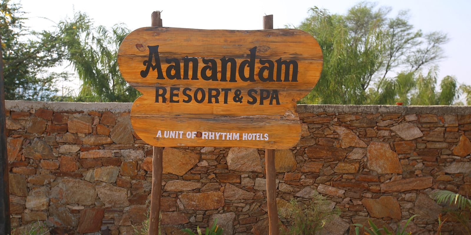 Hotel name board displayed at the entrance of Aanandam Resort & Spa