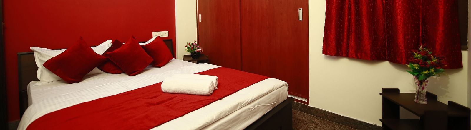 A queen size bed in a room at Tranquil ABS Orchid Serviced Apartments
