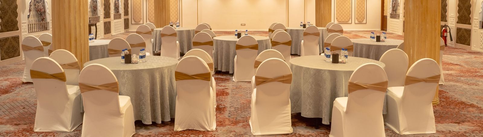 Lavish event space with round tables and grand columns - Kaldan Samudra Palace