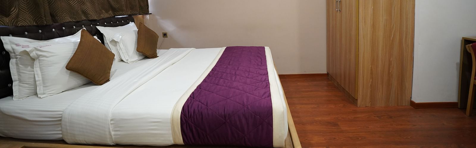 an image of side view of deluxe room with a wardrobe