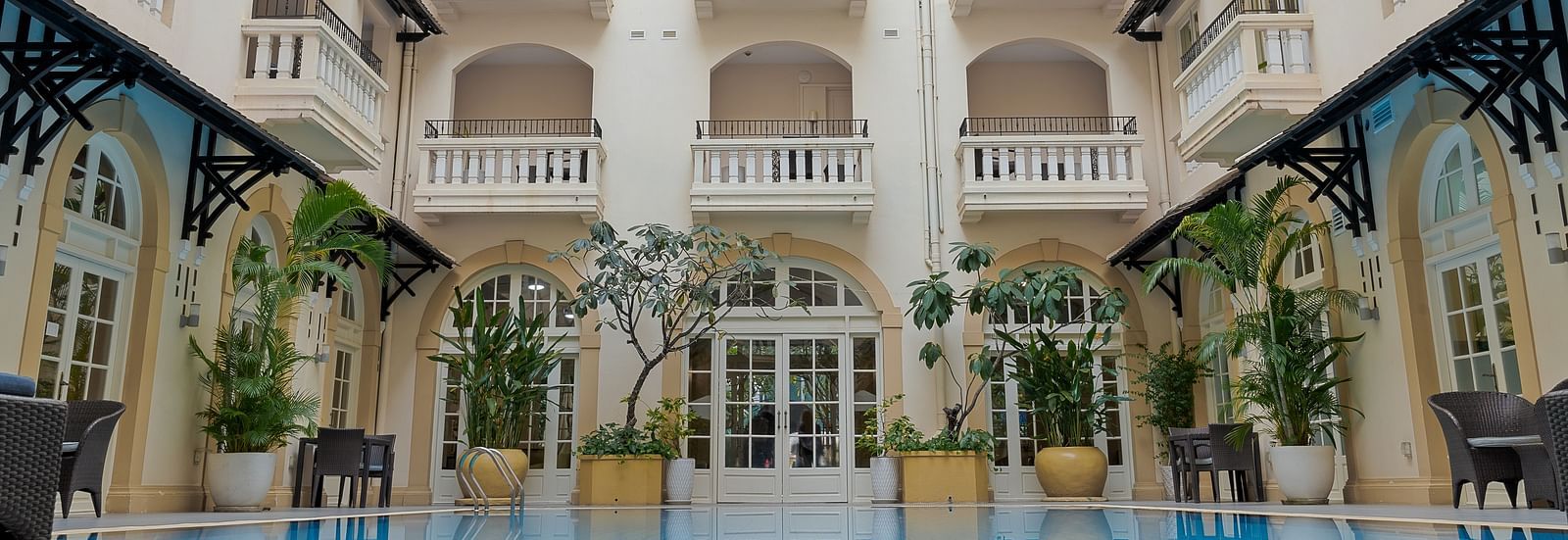 A multi-storey building with an open courtyard and a swimming pool | Central Mansions, Phnom Penh