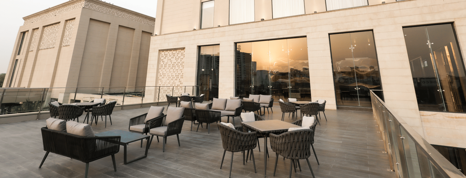 Outdoor seating area with modern furniture at Ramada by Wyndham Sonipat Murthal