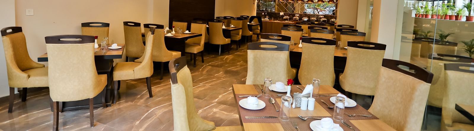 Image of a dining area with tables and chairs at Calux Grand Baga.