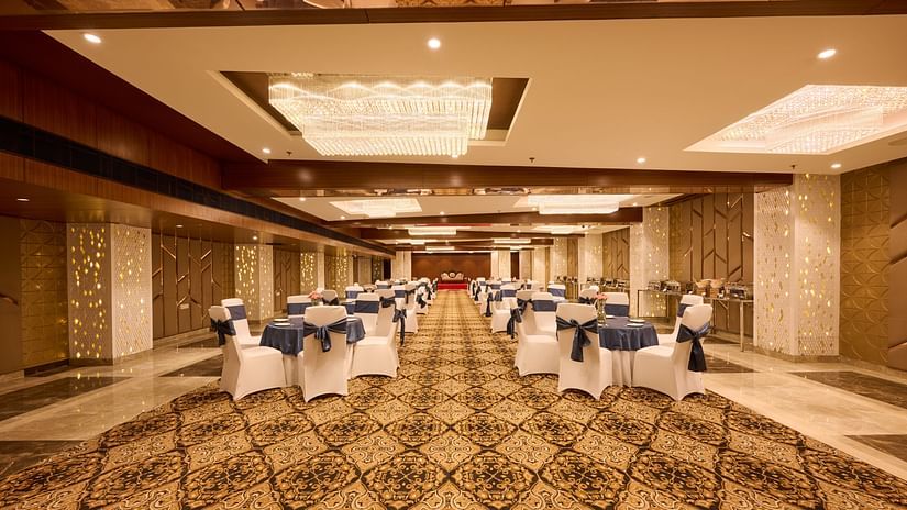 A banquet hall at our hotel with chairs and carpeted flooring