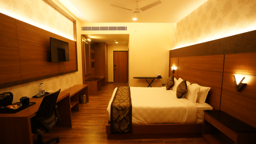 EXECUTIVE KING with a double bed, television mounted on the wall, desk with chair, wooden flooring, lighting, and wall decor at V FIVE HOTEL.