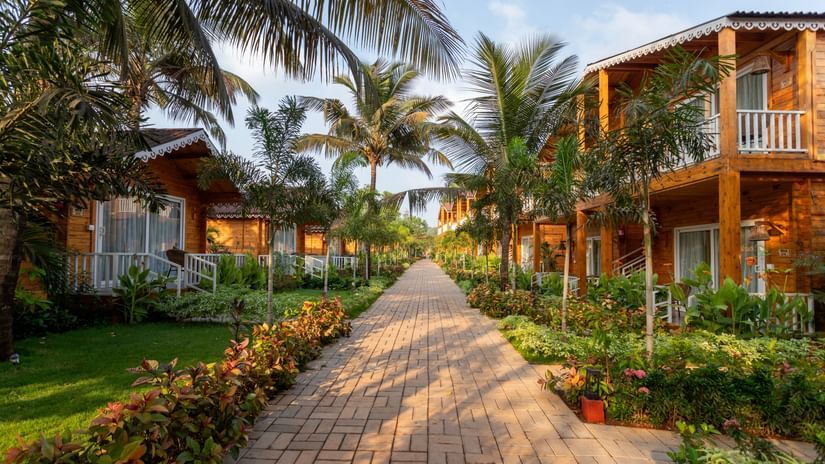 a path surrounded by villas and greenery at Aralea Beach Resort by Stone Wood, Morjim
