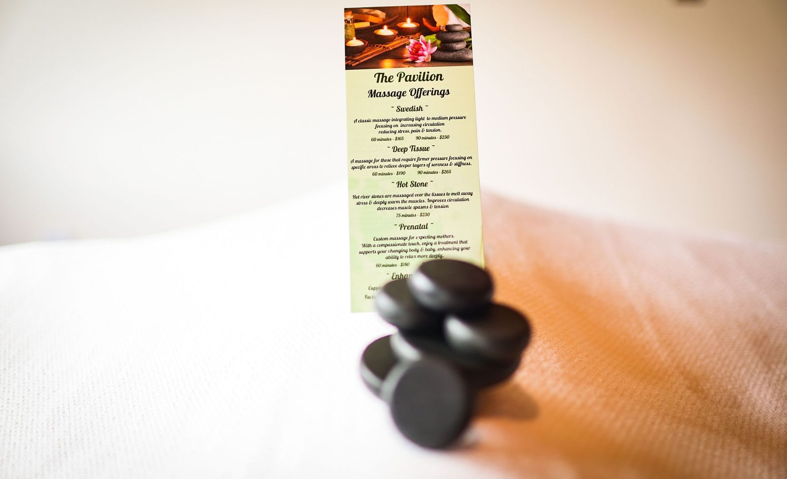 A treatment menu elegantly placed on soft linens at The Pavilion, Brewery Gulch Inn & Spa