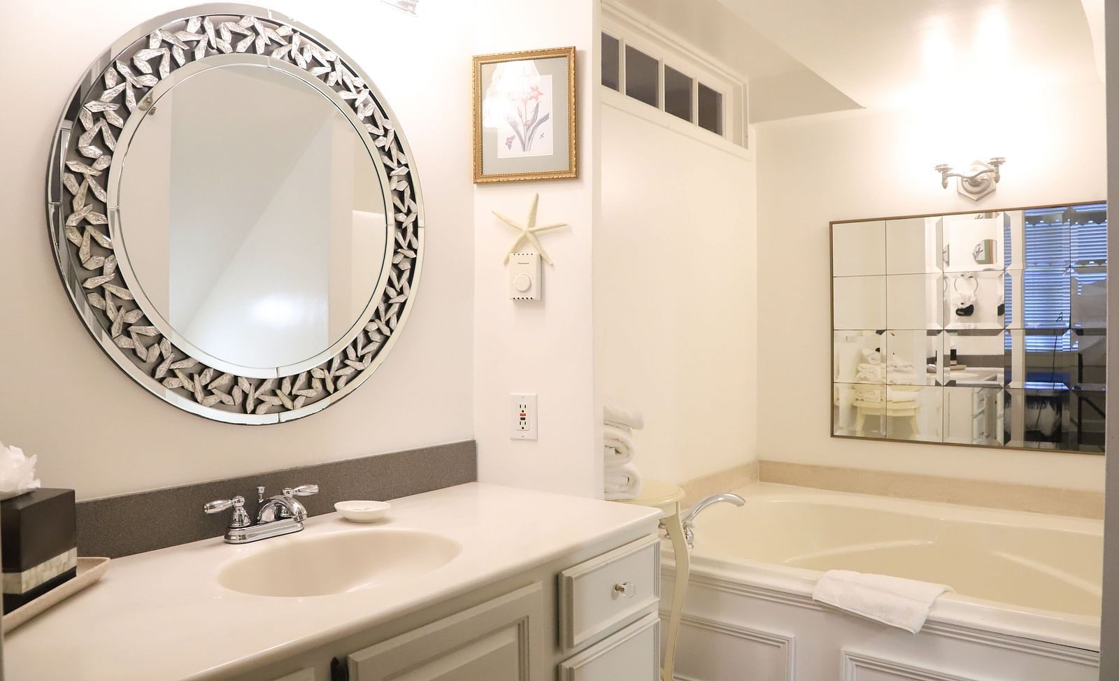 Bathroom with a mirror, sink, and a bathtub at Hartstone Inn.