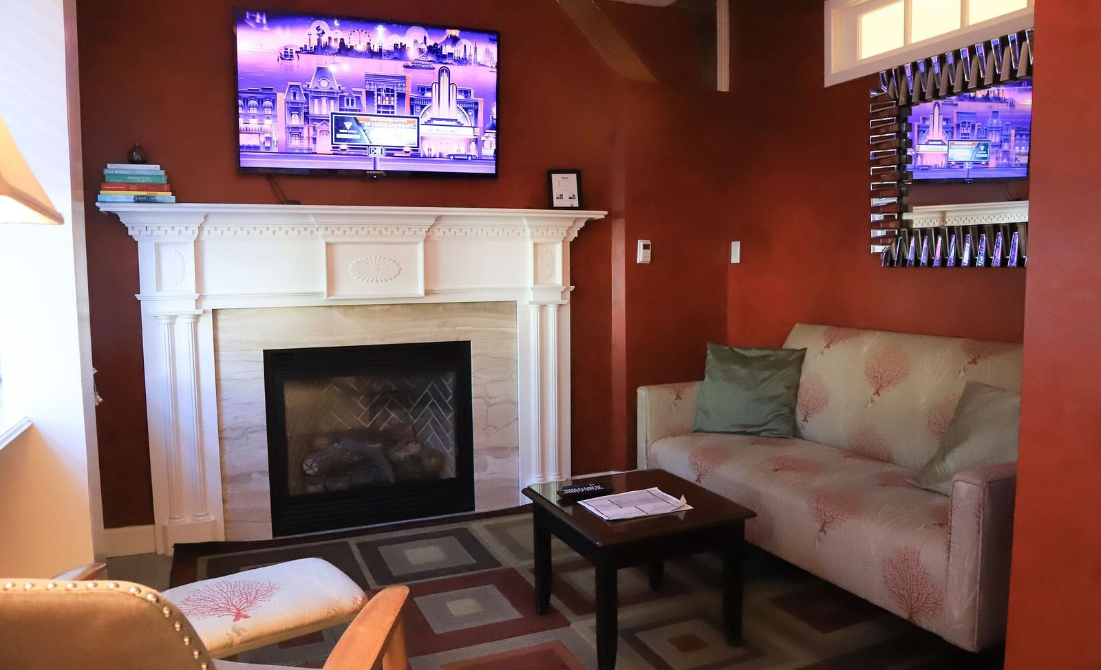 Hotel room with a fireplace, TV, and sofa at Hartstone Inn.